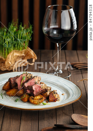 Beef medallions dish with potatoes and mushrooms Beef medallions dish with potatoes and mushrooms 84794318