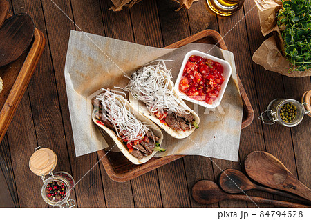 Tacos with beef appetizer with salsa sauce Tacos with beef appetizer with salsa sauce 84794628
