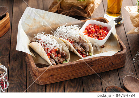 Tacos with beef appetizer with salsa sauce Tacos with beef appetizer with salsa sauce 84794734