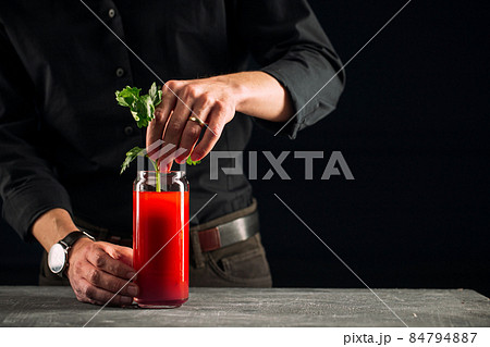 Man making bloody mary cocktail with celery Man making bloody mary cocktail with celery 84794887