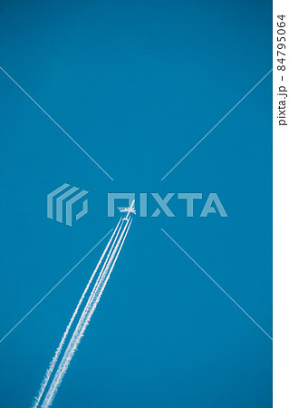 Airplane In The Sky With Plane Trails 84795064