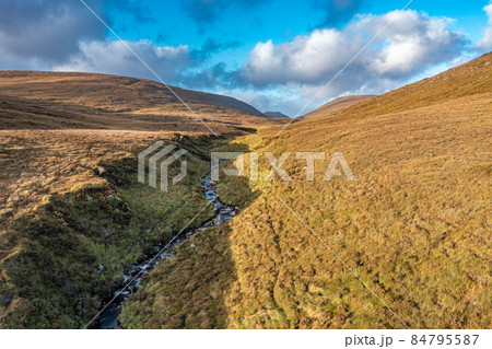 Beatiful stream flowing from the Mountains surrounding Glenveagh National Park - County Donegal, Ireland. Beatiful stream flowing from the Mountains surrounding Glenveagh National Park - County Donegal, Ireland. 84795587