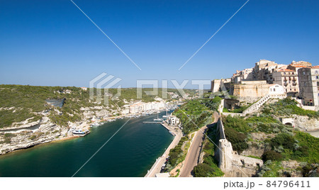 Medieval citadel of Bonifacio with harbor and blue Mediterranean sea under the ramparts 84796411
