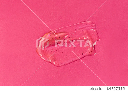 Liquid gel cosmetic product with shimmery particles and bubbles on pink background. Texture and background Liquid gel cosmetic product with shimmery particles and bubbles on pink background. Texture and background 84797556