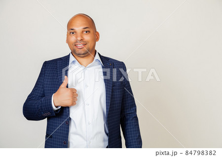 Young African American man making gesture of approval and success with smiling happy hand gesture 84798382