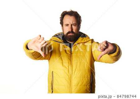 bearded man looking sad, disappointed or angry, showing thumbs down in disagreement, feeling frustrated. bearded man looking sad, disappointed or angry, showing thumbs down in disagreement, feeling frustrated. 84798744