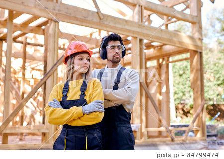 confident constructor engineers in New residential construction home framing. 84799474