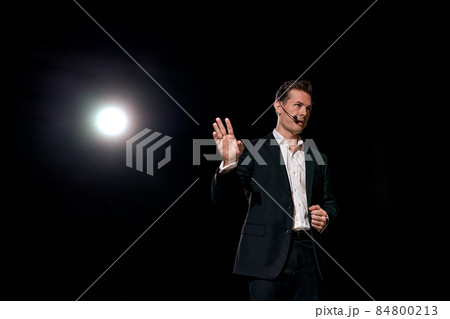confident successful man with microphone speaking at corporate business coaching confident successful man with microphone speaking at corporate business coaching 84800213
