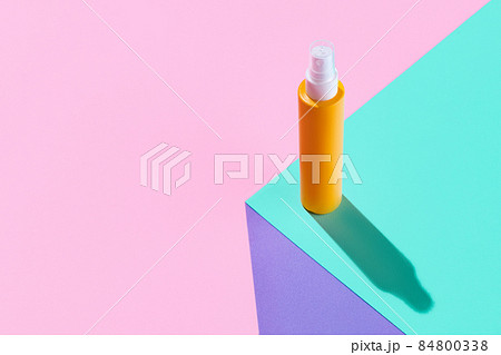One yellow spray bottles for cosmetics, cream, lotion without logos isolated over colored background. 84800338
