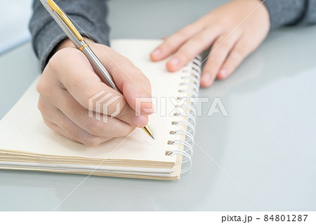 Hands working writing notebook on desk Hands working writing notebook on desk 84801287