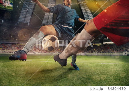 Sportive men, male soccer, football players playing football at the stadium during sport match at crowed stadium. Sport concept Sportive men, male soccer, football players playing football at the stadium during sport match at crowed stadium. Sport concept 84804430