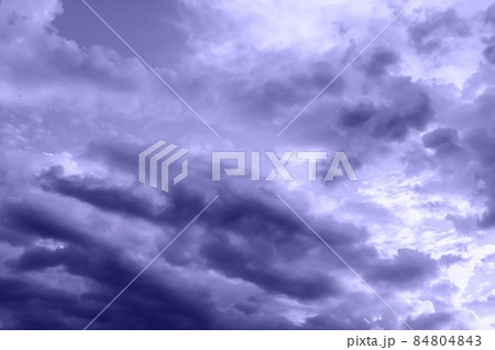 the sky covered with thunderclouds in summer. Trending toning Very Peri color. the sky covered with thunderclouds in summer. Trending toning Very Peri color. 84804843