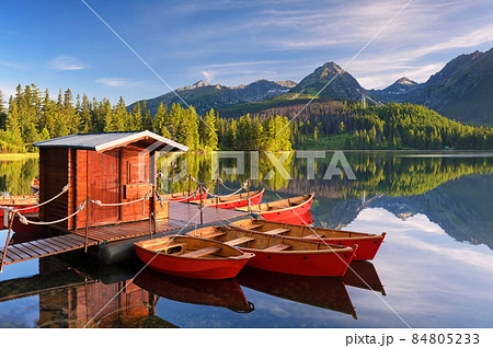 Red boat in a mountain lake Red boat in a mountain lake 84805233