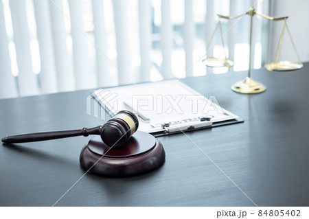 Judge gavel with Justice at law firm in background with legal case document contract, law and justice, attorney, lawsuit 84805402