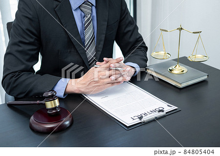 Male lawyer working with legal case document contract in office Male lawyer working with legal case document contract in office 84805404