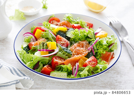 Salted salmon salad with fresh green lettuce, cucumbers, tomato, bell pepper and red onion. Ketogenic, keto or paleo diet lunch bowl Salted salmon salad with fresh green lettuce, cucumbers, tomato, bell pepper and red onion. Ketogenic, keto or paleo diet lunch bowl 84806653