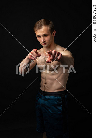 Man on black background keeps dumbbells pumped up in fitness bodybuilding sexy sport, athlete weight workout lifting person weightlifting. Young sportive gym fit fingers point at us Man on black background keeps dumbbells pumped up in fitness bodybuilding sexy sport, athlete weight workout lifting person weightlifting. Young sportive gym fit fingers point at us 84807828