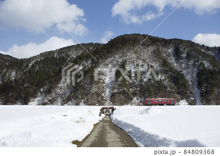 雪の中を走る長良川鉄道の車両、青空 84809368