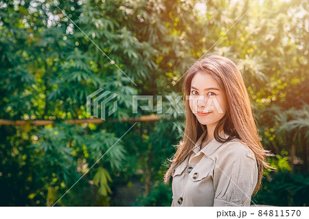 Woman in Cannabis agriculture farm, Girl teen with Marijuana or Hemp green herbal plant happy smile. 84811570