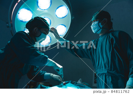 doctor team hard working in operating room attempt to save patient life tried and exhausted doctor team hard working in operating room attempt to save patient life tried and exhausted 84811762