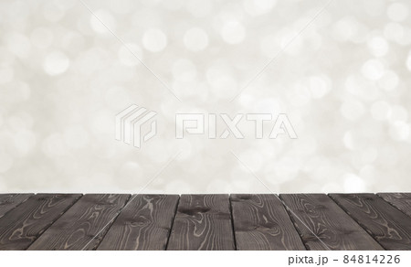 Brown wooden table and white bokeh for festivebackground Brown wooden table and white bokeh for festivebackground 84814226