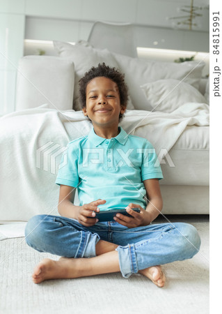 Happy kid boy using phone at home 84815991