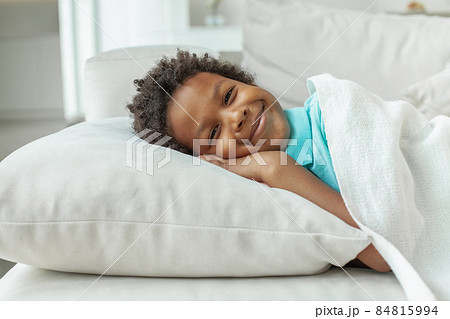 Little kid boy lying in his bed and smiling. Bedtime 84815994