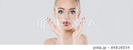 Pretty surprised woman with portrait on white banner background Pretty surprised woman with portrait on white banner background 84816034