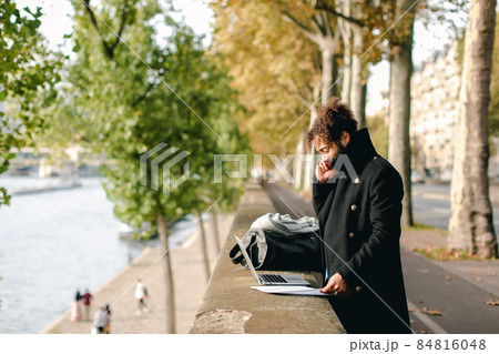 Hispanic professor in detached duty working with laptop. Hispanic professor in detached duty working with laptop. 84816048