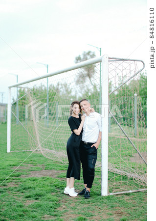 Young woman hugging man in football goal. Young woman hugging man in football goal. 84816110