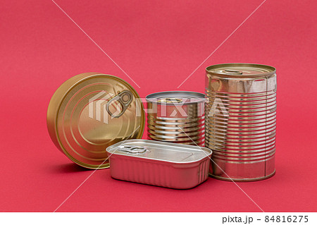 Unopened Tin Cans with Blank Edges on Red Background 84816275