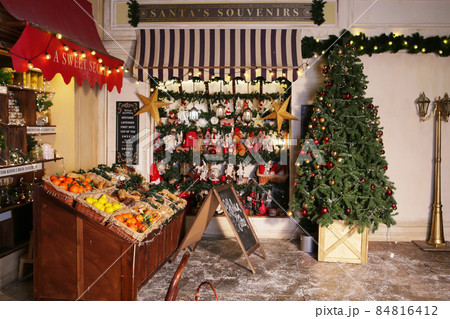 Christmas tree in xmas decorated town fragment with souvenirs shop, cafe and confectionery store 84816412