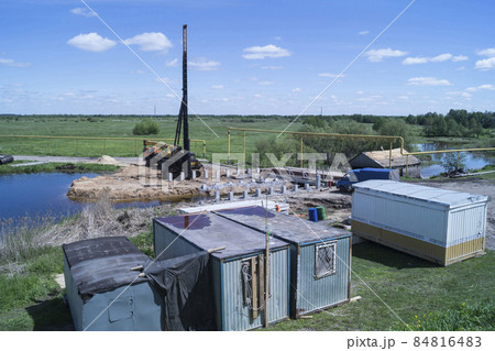 Construction of a bridge across the river in summer Construction of a bridge across the river in summer 84816483