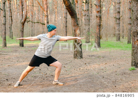 Male person resting and doing workout in morning park. 84816905