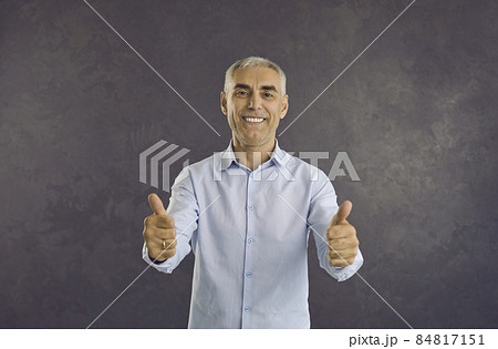Portrait of smiling middle-aged Caucasian man on black studio background show thumb up give recommendation. Happy excited mature male client customer recommend good quality service or deal. Portrait of smiling middle-aged Caucasian man on black studio background show thumb up give recommendation. Happy excited mature male client customer recommend good quality service or deal. 84817151