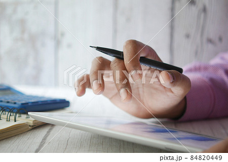 analyzing stock market data on digital tablet  84820449
