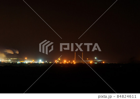 Night view of industrial district of the city and smoke pipes of factory Night view of industrial district of the city and smoke pipes of factory 84824611
