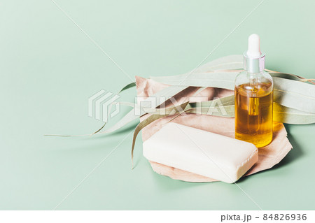 Cosmetic oil bottle and soap bar on craft paper Cosmetic oil bottle and soap bar on craft paper 84826936