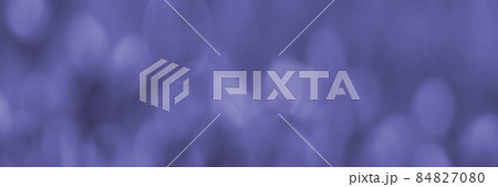 Purple Banner with blurred twinkling lights on a background. For use in the background. soft focus shooting in monochrome color. Copy space. The fashionable color of 2022. Very peri color background. 84827080