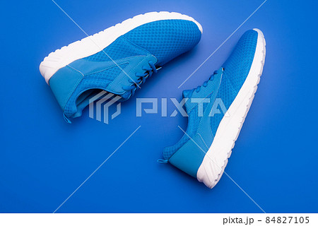 sporty blue sneakers. shoes on blue background. shoe store. shopping concept. 84827105