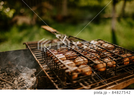mushrooms champignons stacked in a barbecue on the grill 84827542