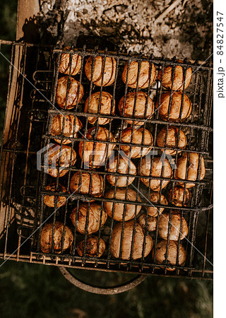 mushrooms champignons stacked in a barbecue on the grill mushrooms champignons stacked in a barbecue on the grill 84827547