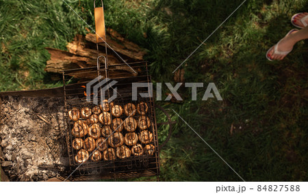 mushrooms champignons stacked in a barbecue on the grill mushrooms champignons stacked in a barbecue on the grill 84827588