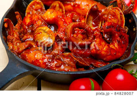 fresh seafoos stew on an iron skillet 84828007