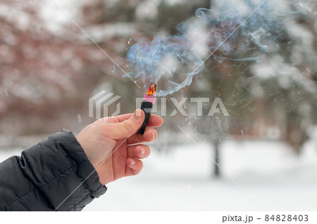Burning Firecracker in a Hand. Sparks and Smoke of Petard Burning Firecracker in a Hand. Sparks and Smoke of Petard 84828403