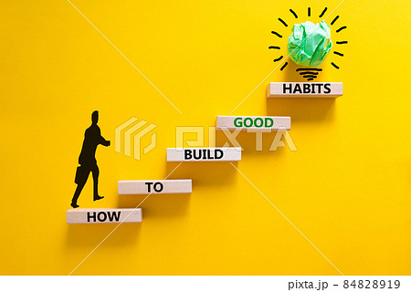 Build good habits symbol. Wooden blocks on beautiful yellow background, copy space. Words 'How to build good habits'. Businessman icon. Build good habits concept. Copy space. 84828919