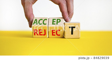 Accept or reject symbol. Businessman turns wooden cubes and changes the word reject to accept. Beautiful yellow table, white background, copy space. Business and accept or reject concept. 84829039