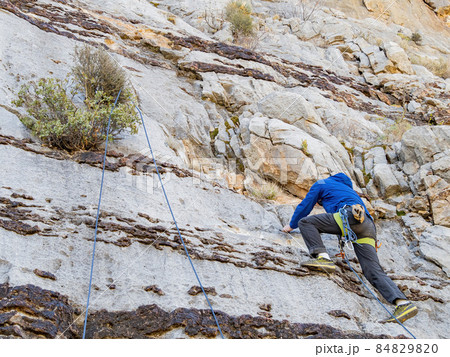People doing rock climbing sports People doing rock climbing sports 84829820