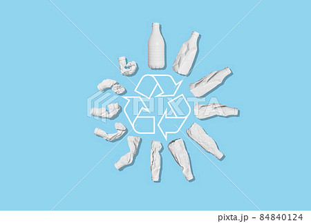 Recycling of plastic waste. A white plastic bottle is deformed against an empty blue background. Ecology, recycling, environmental protection, concept. Recycling of plastic waste. A white plastic bottle is deformed against an empty blue background. Ecology, recycling, environmental protection, concept. 84840124
