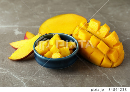 Tasty ripe mango fruit on gray textured background 84844238